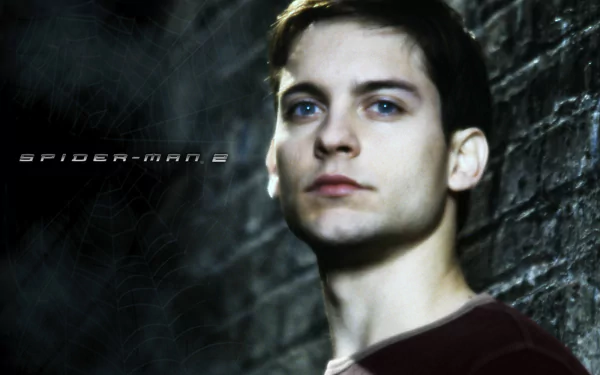 High-definition desktop wallpaper featuring Tobey Maguire as Peter Parker in Spider-Man 2, capturing the essence of the iconic superhero amidst a moody backdrop.