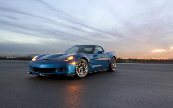 HD desktop wallpaper featuring a blue Chevrolet Corvette ZR1 parked on an open road at sunset, showcasing the sleek design of this iconic Chevrolet vehicle.