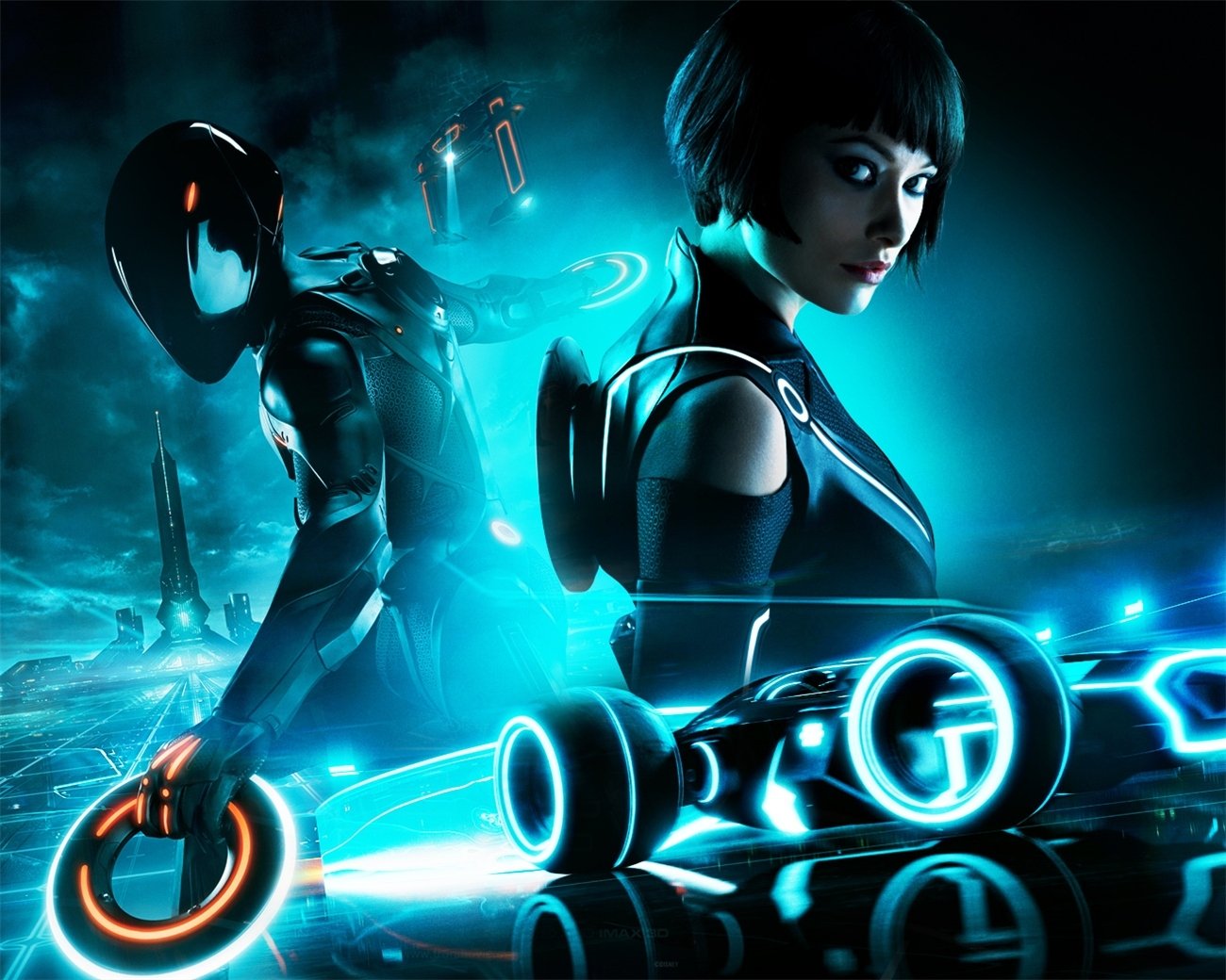 Movie, TRON: Legacy HD PC desktop wallpaper of two light‑suited figures back‑to‑back, glowing identity discs and neon blue light cycles streaking across a digital grid.