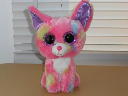 Colorful, man-made Beanie Boo plush with large black eyes, displayed indoors, featured as an HD PC desktop wallpaper and background.