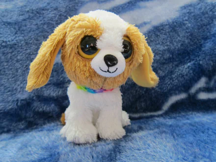 HD desktop wallpaper featuring a man-made Beanie Boos plush dog with large eyes against a soft blue textured background.