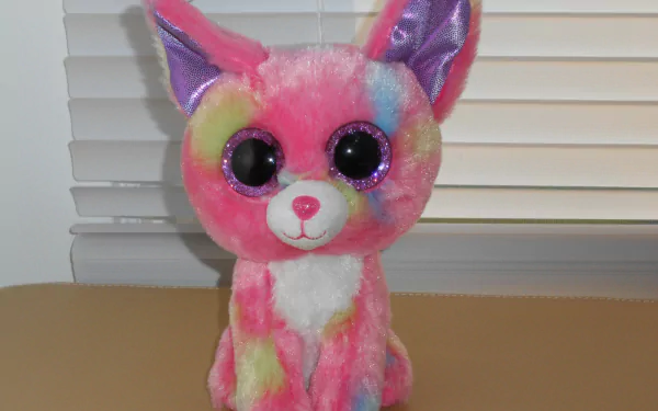 Colorful, man-made Beanie Boo plush with large black eyes, displayed indoors, featured as an HD PC desktop wallpaper and background.