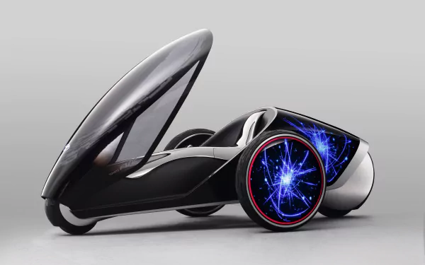 Futuristic three-wheeled Toyota concept vehicle with enclosed cockpit and neon-blue energy-effect wheels on neutral background — 5K Ultra HD PC desktop wallpaper and background.