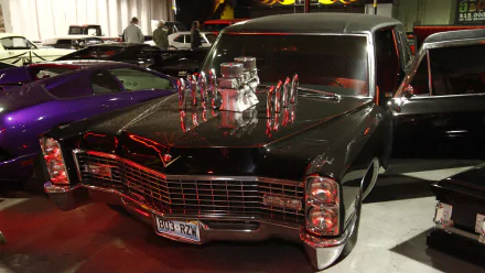 4K Ultra HD desktop wallpaper featuring a classic black car from the TV show Counting Cars, showcased in a garage setting with vibrant lighting.