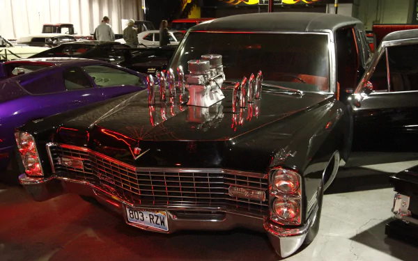 4K Ultra HD desktop wallpaper featuring a classic black car from the TV show Counting Cars, showcased in a garage setting with vibrant lighting.