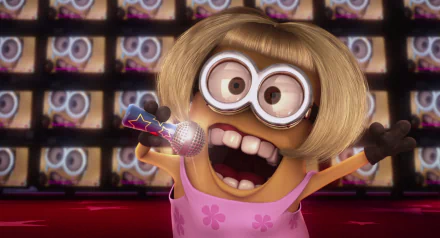 A HD desktop wallpaper featuring a character from the movie Despicable Me, depicting a Minion in a pink dress and blonde wig, passionately singing into a microphone with a background of screens.