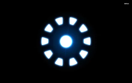 HD desktop wallpaper featuring the glowing arc reactor from the movie Iron Man against a black background.