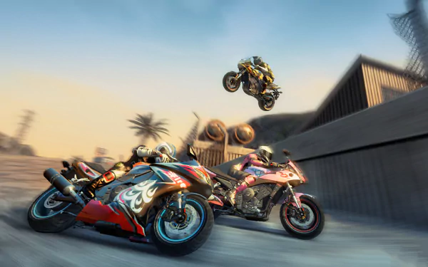 A dynamic HD PC desktop wallpaper featuring intense motorcycle action from the video game Burnout Paradise, showcasing two bikes racing and one leaping through the air against a vibrant sunset backdrop.