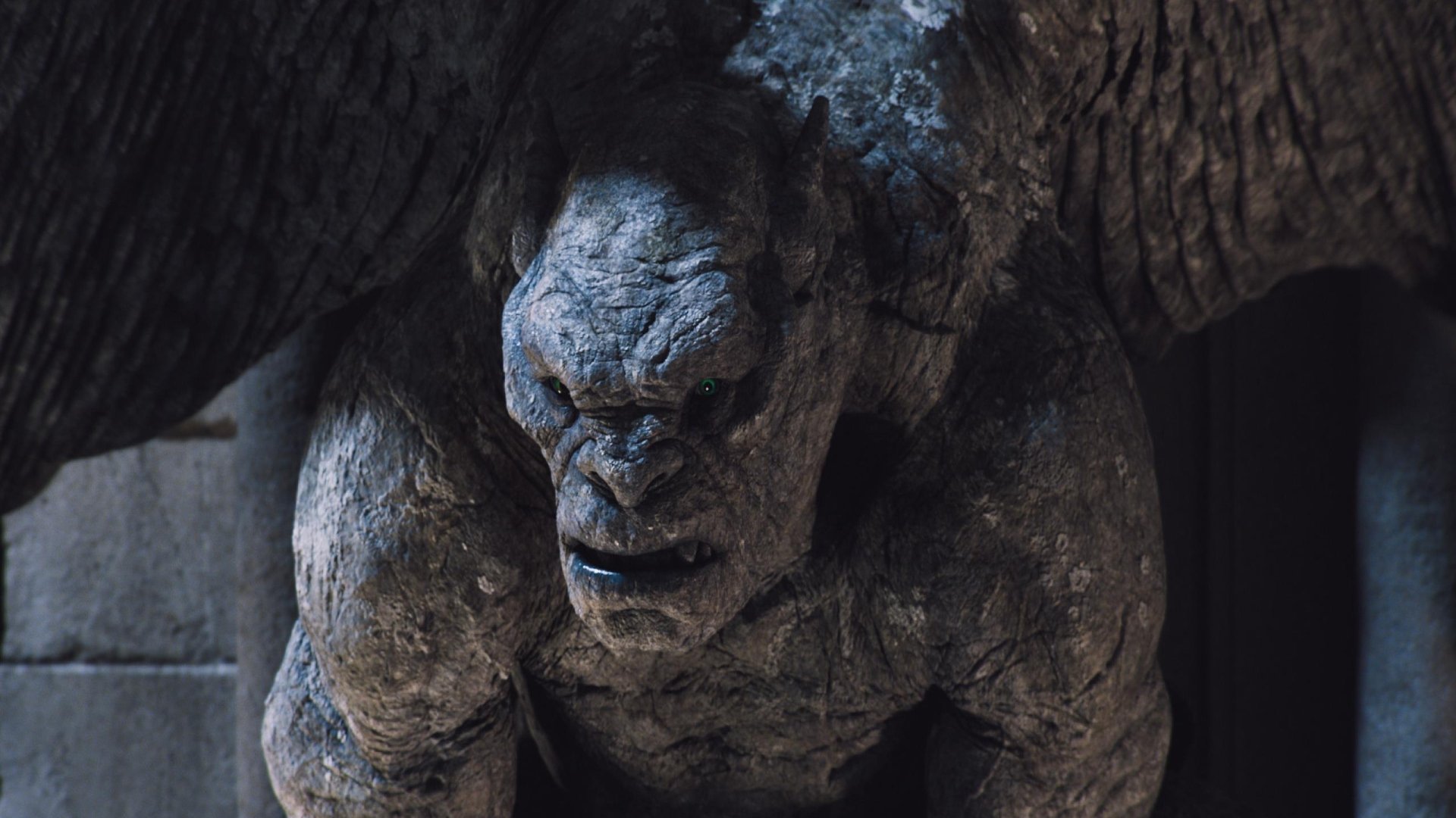 HD PC desktop wallpaper featuring a close-up of a menacing stone gargoyle from the movie Frankenstein, showcasing detailed textures and dramatic lighting.