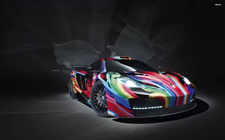HD desktop wallpaper of a McLaren MP4-12C featuring a vivid, multi-colored abstract paint design against a dark, textured background.