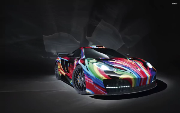 HD desktop wallpaper of a McLaren MP4-12C featuring a vivid, multi-colored abstract paint design against a dark, textured background.