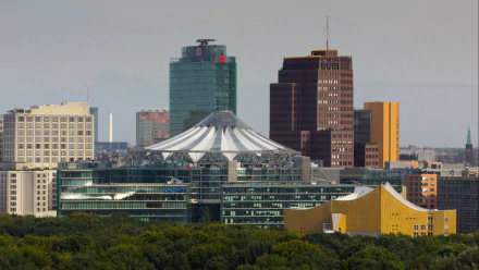A stunning HD wallpaper featuring Berlin's skyline, showcasing modern architecture with a distinctive tent-like structure and a backdrop of towering buildings.