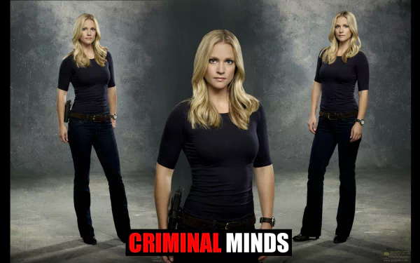 HD desktop wallpaper featuring a character from the TV show Criminal Minds, standing confidently in a dark top and jeans against a textured background.