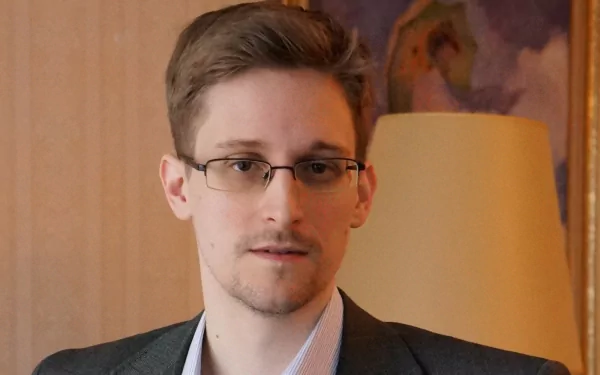 HD desktop wallpaper featuring a portrait of a man in a suit, set against a warm interior background.