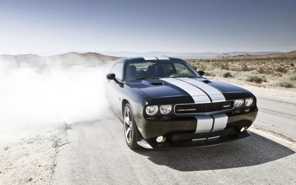 Black Dodge Challenger SRT8 392 with white racing stripes kicking up dust on a desert road — HD PC desktop wallpaper of the vehicle.