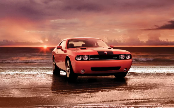 A red Dodge Challenger SRT8 parked on a wet beach at sunset, captured in an HD PC desktop wallpaper background.