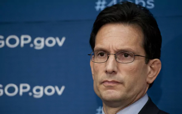 HD desktop wallpaper featuring a man in glasses with a serious expression, in front of a backdrop with the text #GOP.gov.