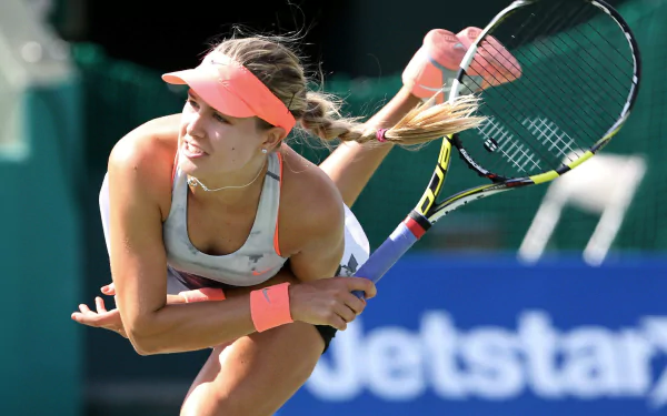 Eugenie Bouchard in action during a tennis match, captured in a high-definition sports-themed PC desktop wallpaper.