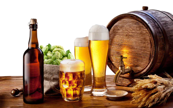 A vibrant HD desktop wallpaper featuring bottles and glasses of beer, a wooden barrel, fresh hops, and a backdrop of golden wheat, perfect for food and beer enthusiasts.