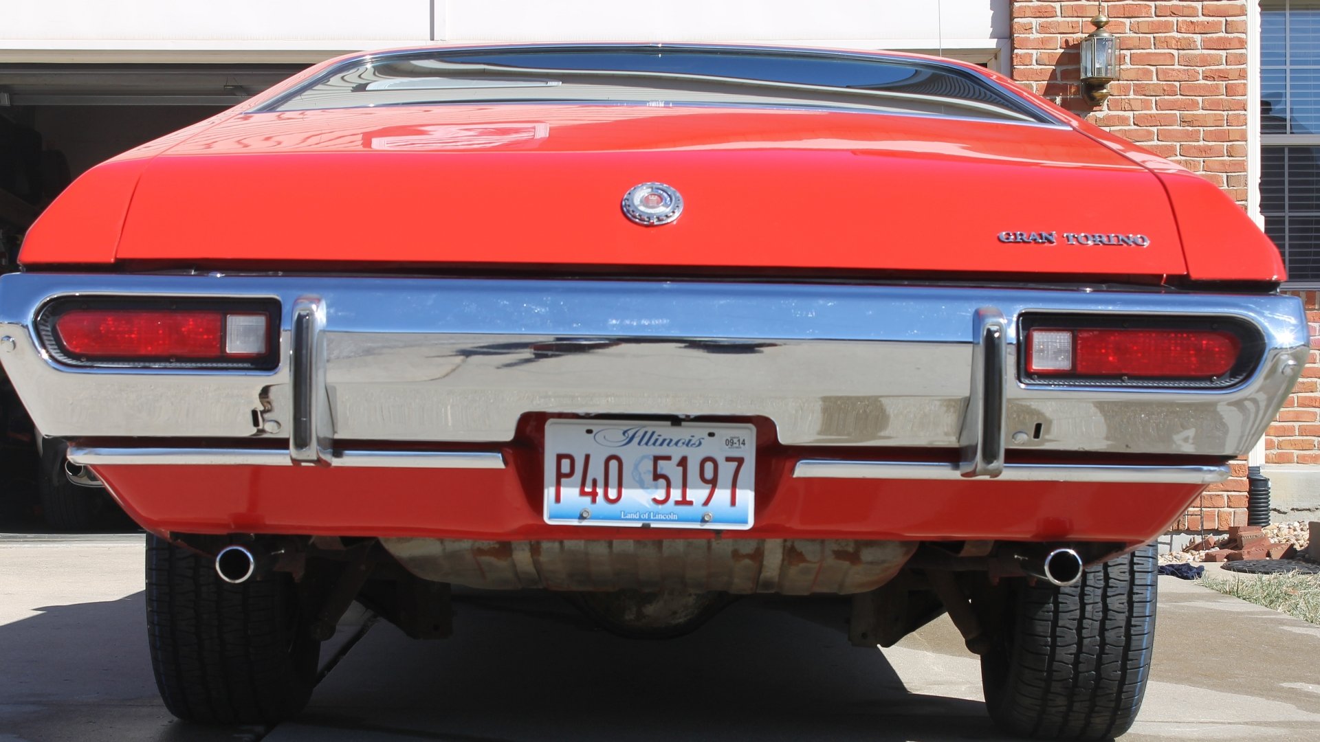 Rear view of a bright red Ford Gran Torino with Illinois plates, showcased in a 4K Ultra HD PC desktop wallpaper and background.