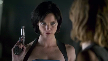 Sienna Guillory in a gripping scene from Resident Evil: Apocalypse, showcasing a tense moment with a gun, captured in stunning 4K Ultra HD for your desktop wallpaper.