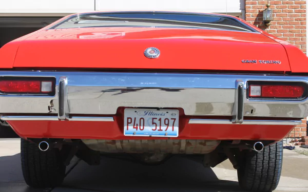 Rear view of a bright red Ford Gran Torino with Illinois plates, showcased in a 4K Ultra HD PC desktop wallpaper and background.