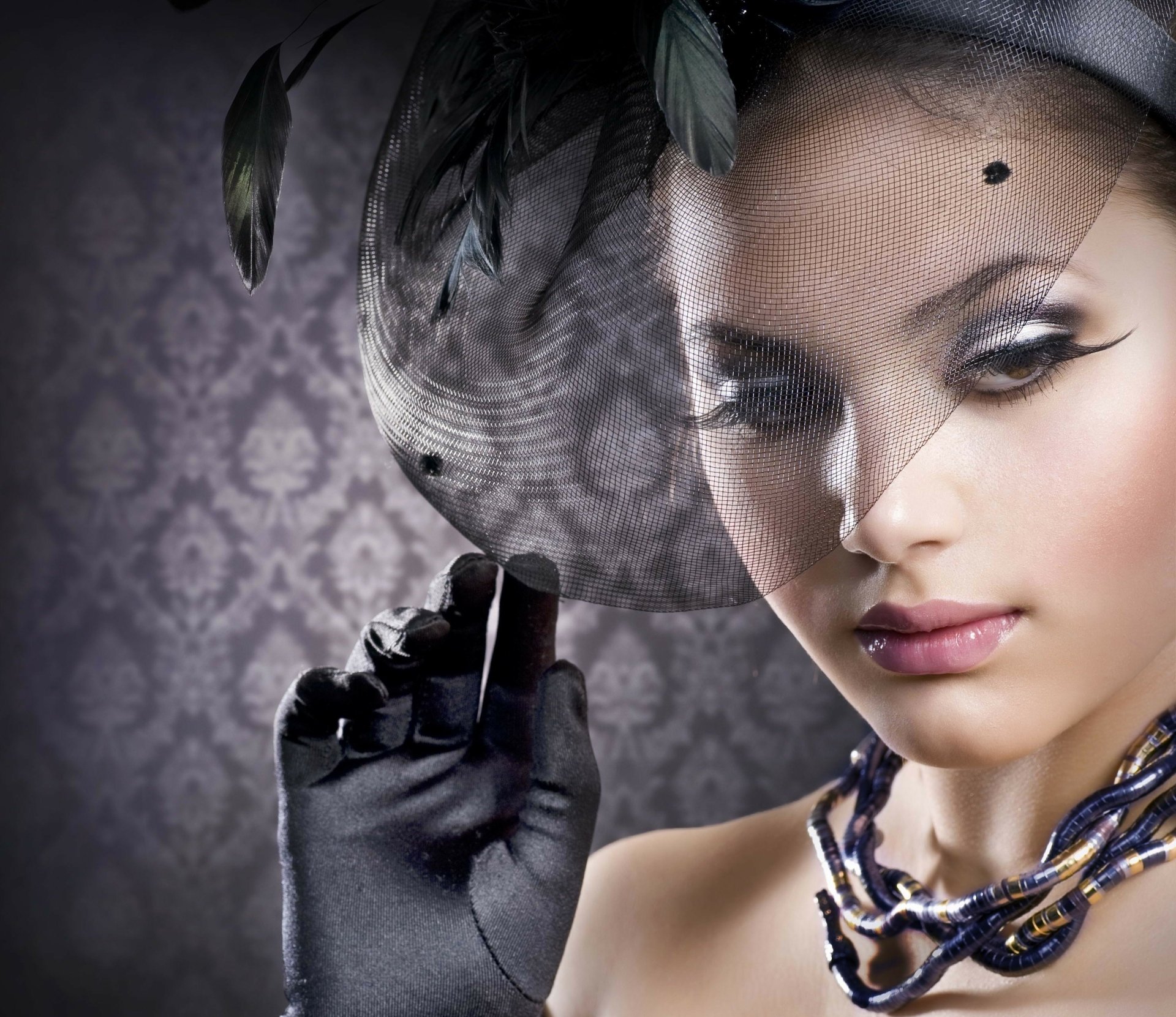 HD desktop wallpaper of a fashion model, Judy Wilkins, wearing a stylish hat with a veil, showcasing elegant makeup and gloves against a patterned background.