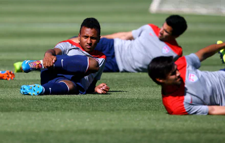 HD soccer-themed desktop wallpaper featuring players stretching on the field.