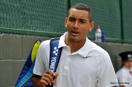 A high-definition desktop wallpaper featuring Nick Kyrgios, showcasing his confident demeanor as he walks with a tennis bag, emphasizing his presence in the sports world.