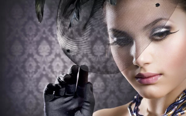 HD desktop wallpaper of a fashion model, Judy Wilkins, wearing a stylish hat with a veil, showcasing elegant makeup and gloves against a patterned background.