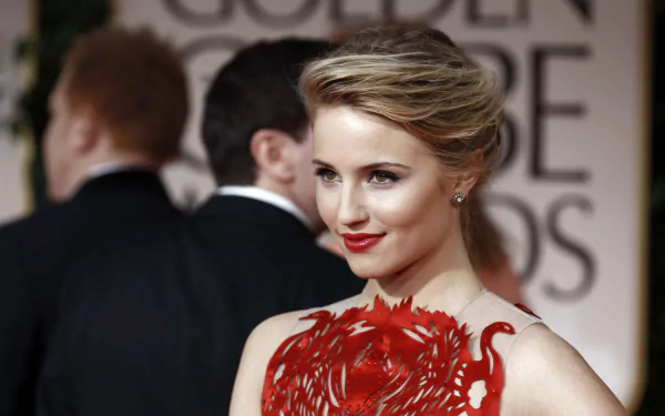 American actress and celebrity Dianna Agron poses elegantly in a red dress at an event, captured in a high-definition PC desktop wallpaper and background.