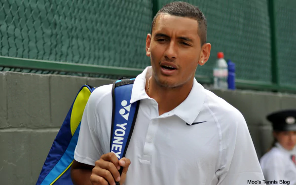 A high-definition desktop wallpaper featuring Nick Kyrgios, showcasing his confident demeanor as he walks with a tennis bag, emphasizing his presence in the sports world.