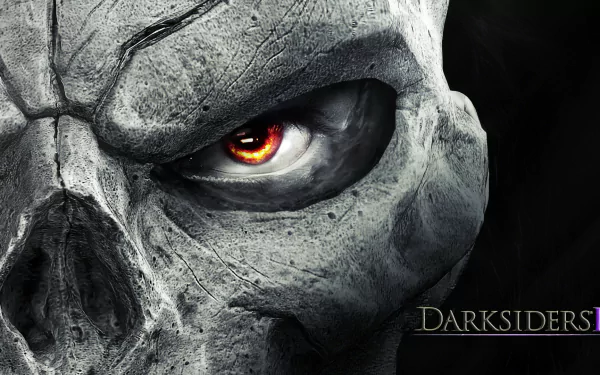 Close-up of a detailed stone skull with a fiery eye from the video game Darksiders II, presented as an HD PC desktop wallpaper and background.