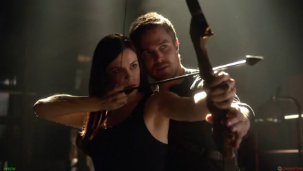 An HD desktop wallpaper featuring Stephen Amell in a dynamic scene from the TV show Arrow, showcasing intense archery action and dramatic lighting.