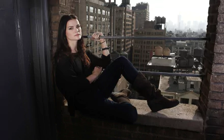 HD desktop wallpaper featuring American actress and celebrity Jaimie Alexander posing confidently in a cityscape setting.