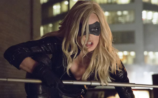 Caity Lotz as Black Canary, poised dramatically on a rooftop, showcasing her fierce presence from the TV show Arrow. This HD wallpaper captures the essence of her superhero role.
