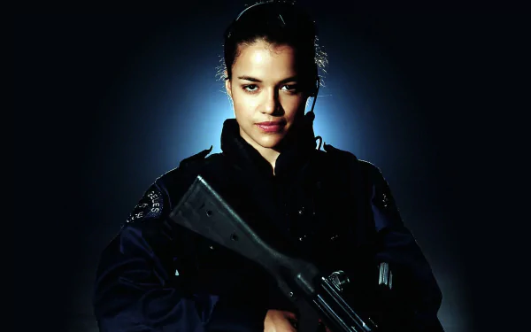 HD desktop wallpaper featuring Michelle Rodriguez from the movie S.W.A.T. (2003), showcasing her in tactical gear with a focused expression against a dark background.