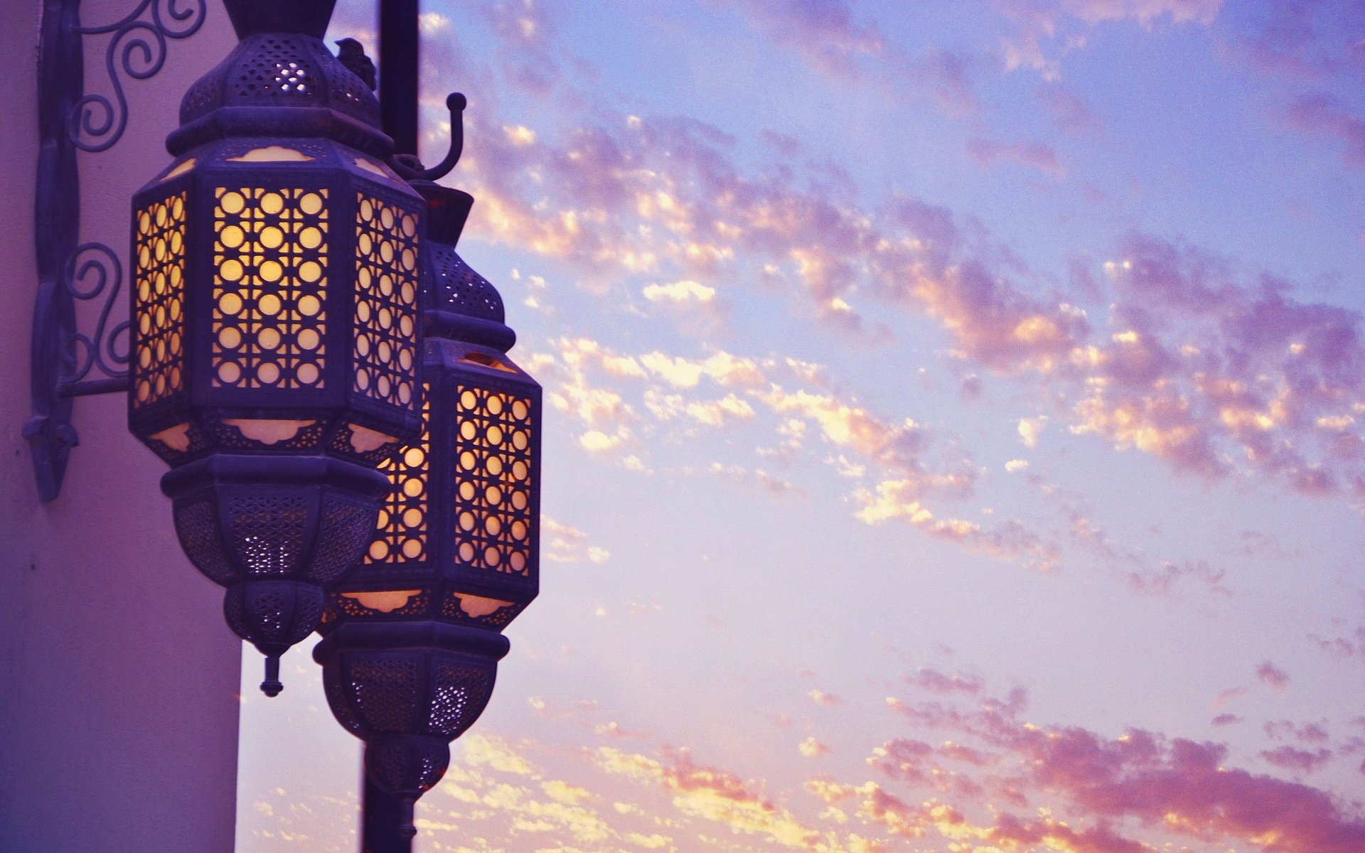 Man-made ornate lanterns glowing against a pastel sunset sky — HD PC desktop wallpaper background