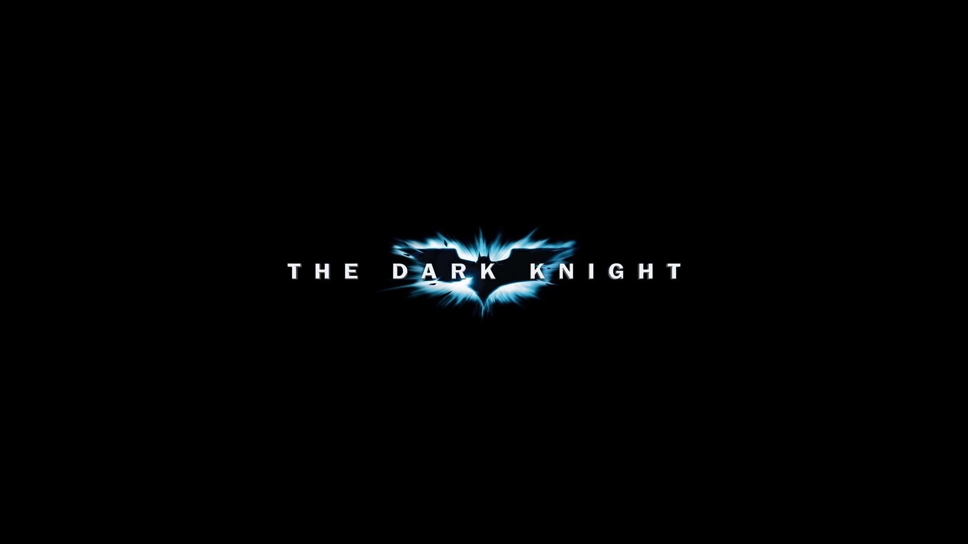 HD PC desktop wallpaper featuring the logo of the movie The Dark Knight, with a sleek black background and glowing blue bat symbol.