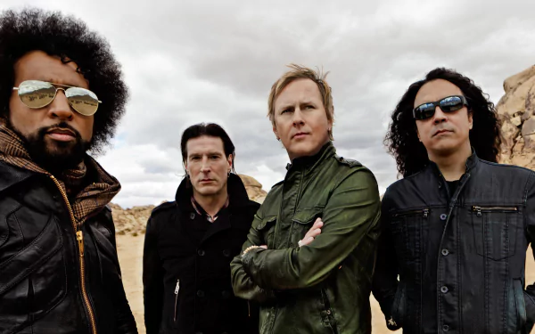 HD desktop wallpaper featuring the rock band Alice In Chains posing outdoors under a cloudy sky, reflecting their music style and iconic presence.
