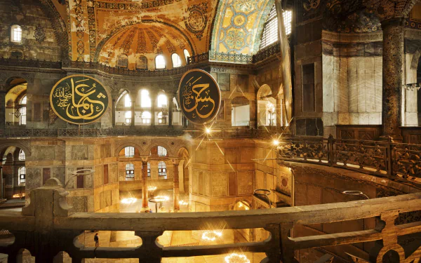 A stunning HD wallpaper featuring the interior of Hagia Sophia, showcasing its architectural grandeur and religious significance with intricate designs and large calligraphic panels.