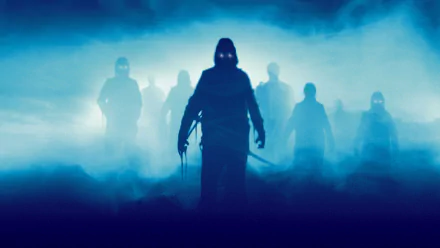 HD PC desktop wallpaper: shadowy, glowing-eyed figures emerging from blue fog, evocative horror scene from the 1980 film The Fog.