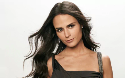 HD desktop wallpaper featuring Brazilian actress and celebrity Jordana Brewster with flowing dark hair and a confident expression against a plain white background.