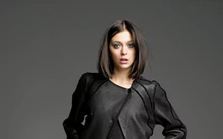 HD desktop wallpaper featuring French model Morgane Dubled in a sleek black outfit against a plain gray background.