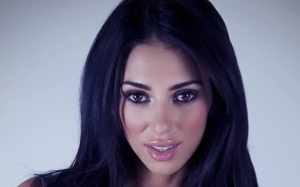 HD desktop wallpaper featuring Irish model and celebrity Georgia Salpa with dark hair, striking eyes, and a polished makeup look against a soft, neutral background.