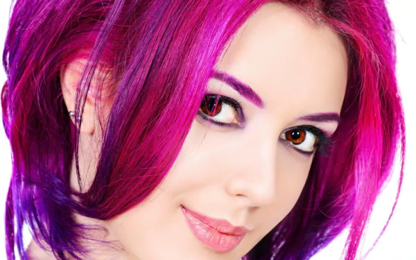 HD desktop wallpaper featuring a close-up of a smiling woman with crimson hair and striking eyes, showcasing a vibrant and confident model's face.