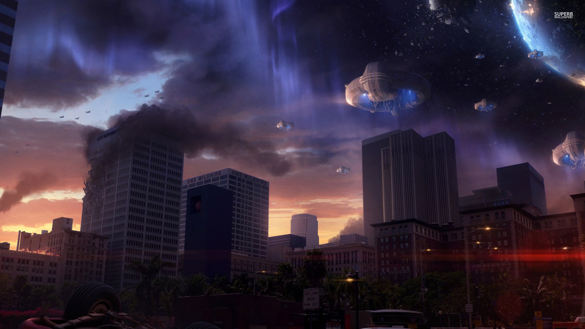 HD sci-fi space invasion desktop wallpaper depicting dark city buildings under an ominous sky with alien ships and a visible planet in the background.