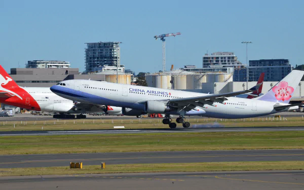 A China Airways Airbus A330 takes off at Sydney Airport, showcasing the aircraft against a clear blue sky and modern cityscape in the background.