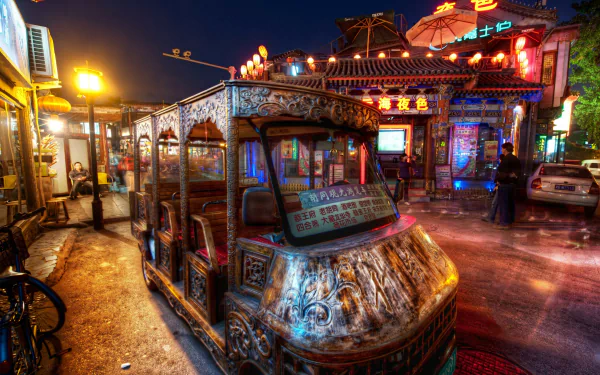 A vibrant night scene in Beijing featuring a beautifully crafted man-made vehicle alongside bustling shops, illuminated by colorful lights, showcasing the city's dynamic atmosphere.