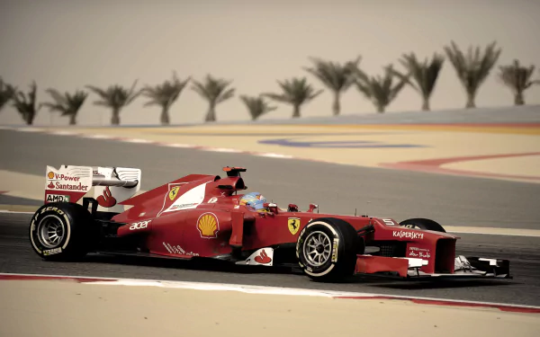 Fernando Alonso driving a red Ferrari F1 racing car on a race track, captured in high-definition for a sports-themed desktop wallpaper.